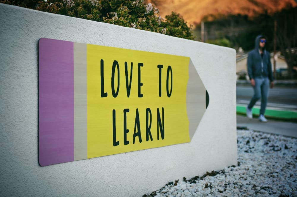 A hand-painted "Love to Learn" sign